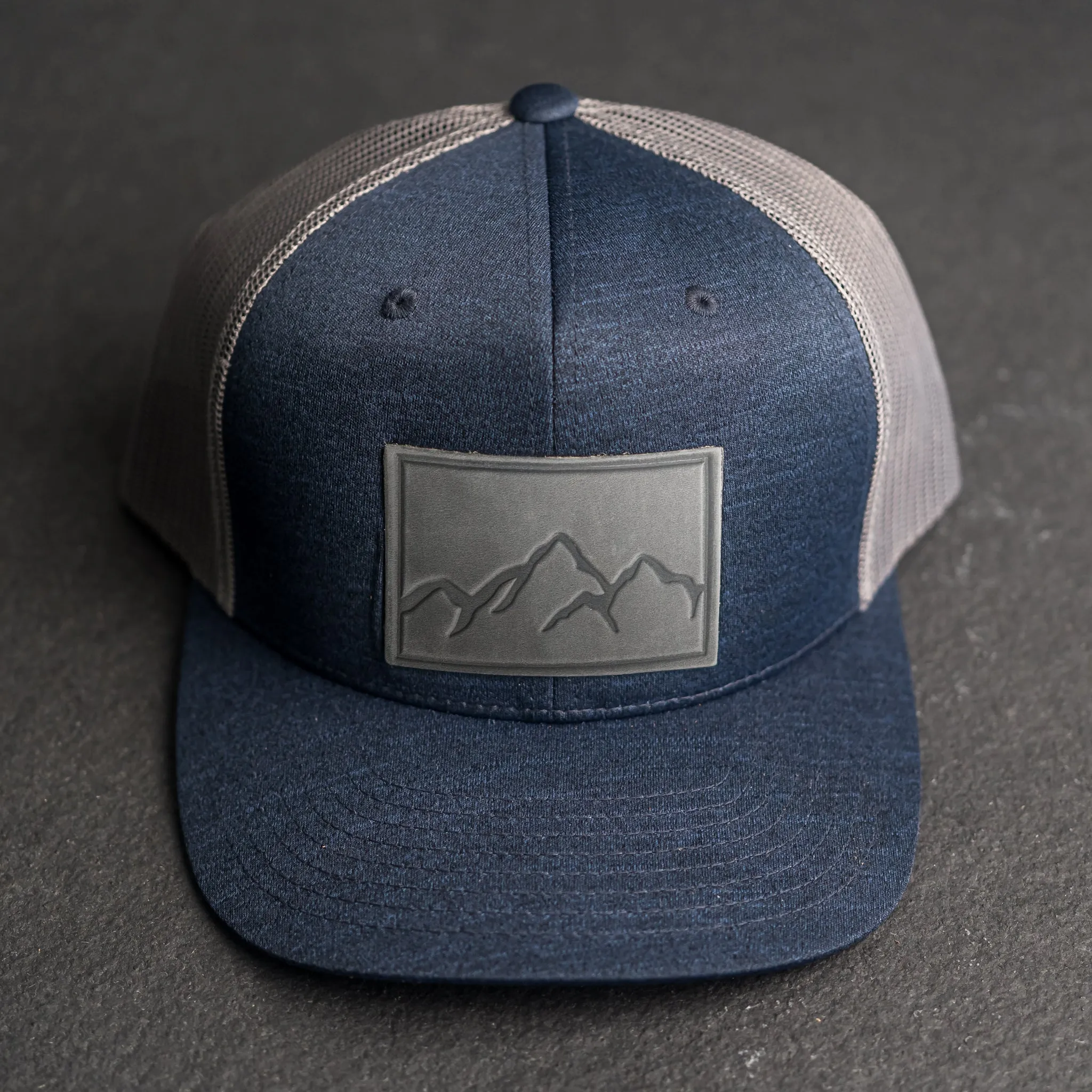 Leather Patch Performance Style Trucker Hat - Mountain Range Stamp