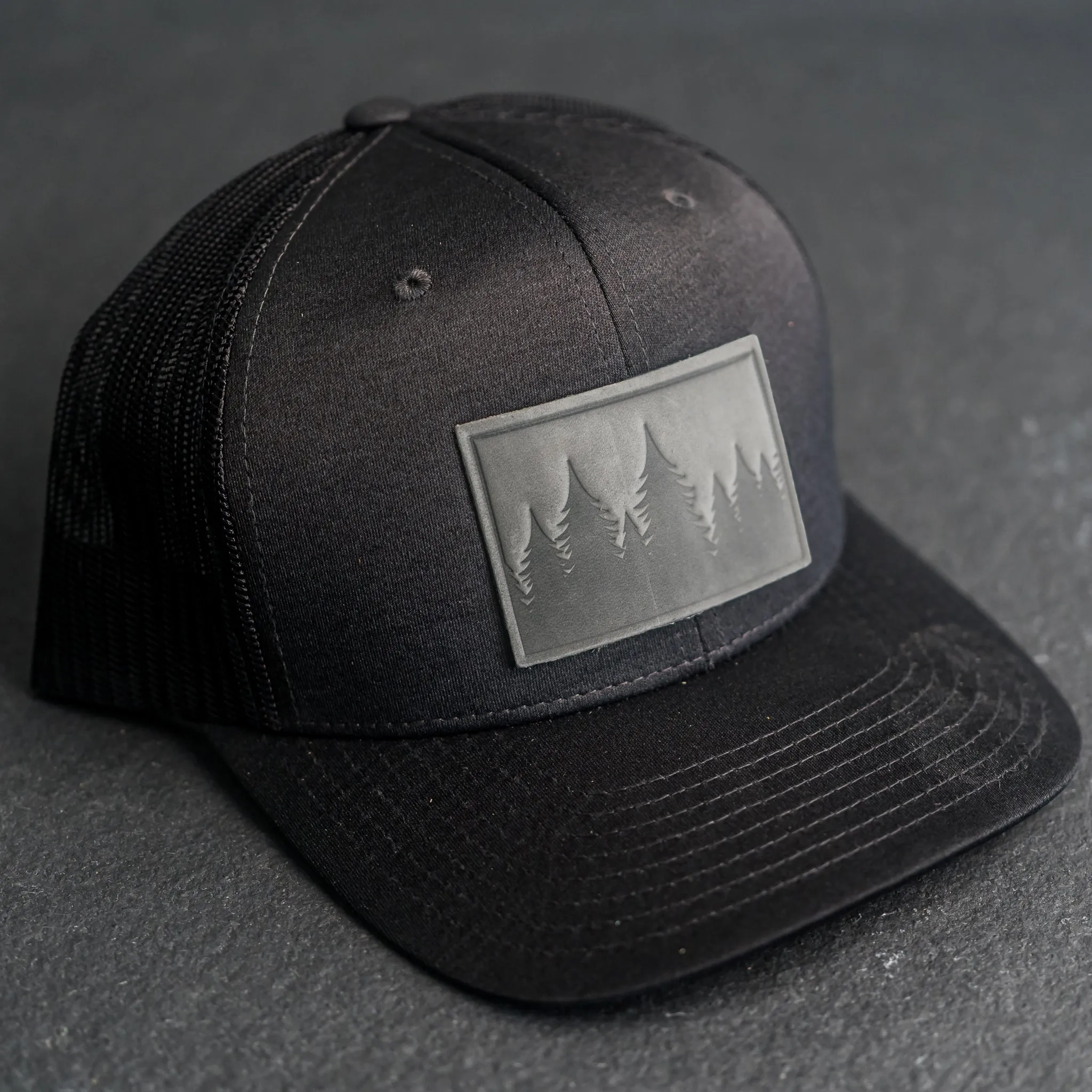 Leather Patch Performance Style Trucker Hat - Pine Tree Ridgeline Stamp