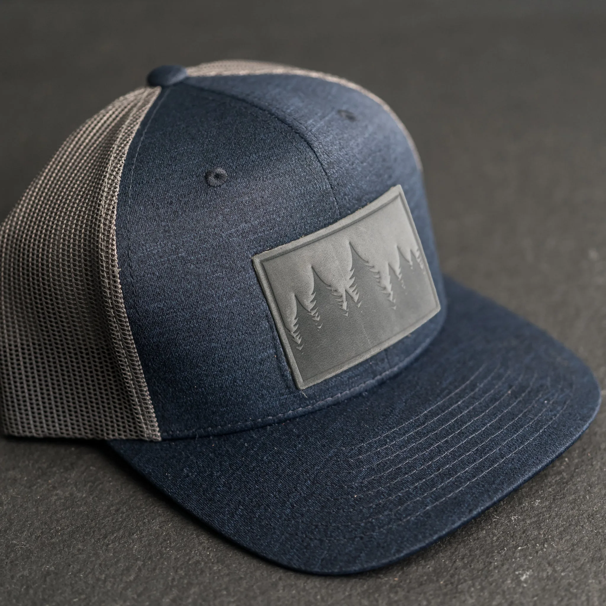 Leather Patch Performance Style Trucker Hat - Pine Tree Ridgeline Stamp